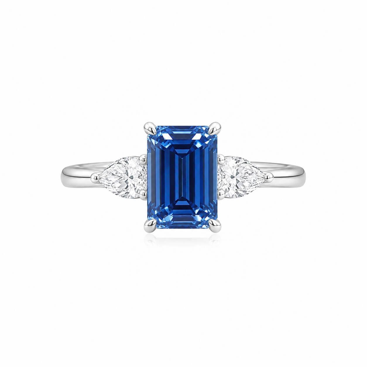 Smaragdgeslepen, in het laboratorium gekweekte blauwe diamanten verlovingsring met drie stenen Smaragdgeslepen, in het laboratorium gekweekte blauwe diamanten verlovingsring met drie stenen