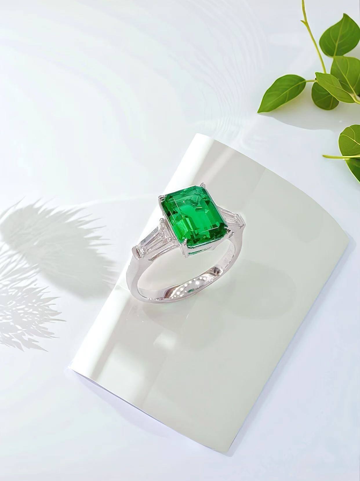 Emerald cut lab grown emerald three stones engagement ring 01
