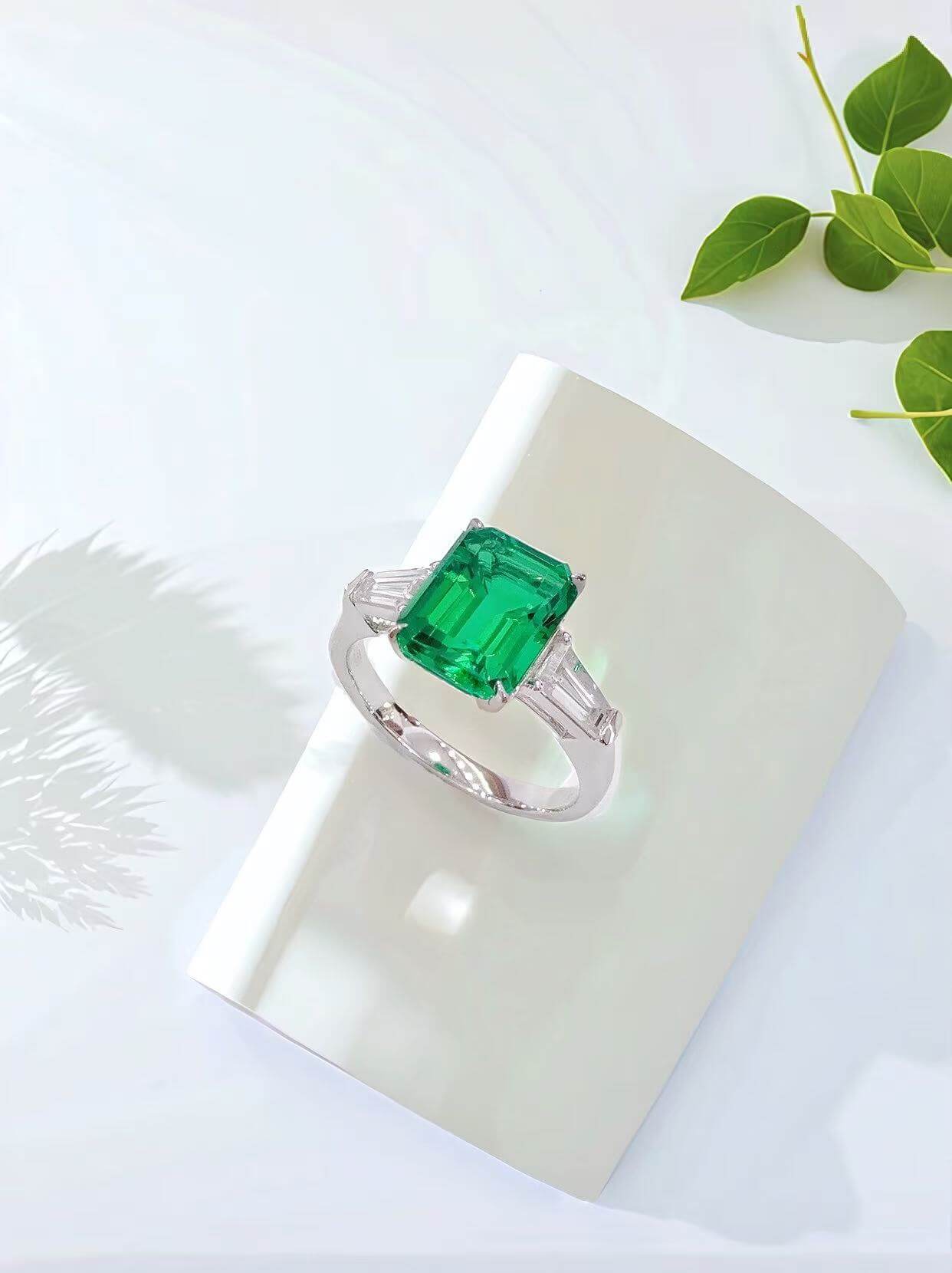 Emerald cut lab grown emerald three stones engagement ring 01