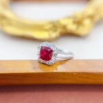 Halo setting cushion cut lab grown ruby engagement ring