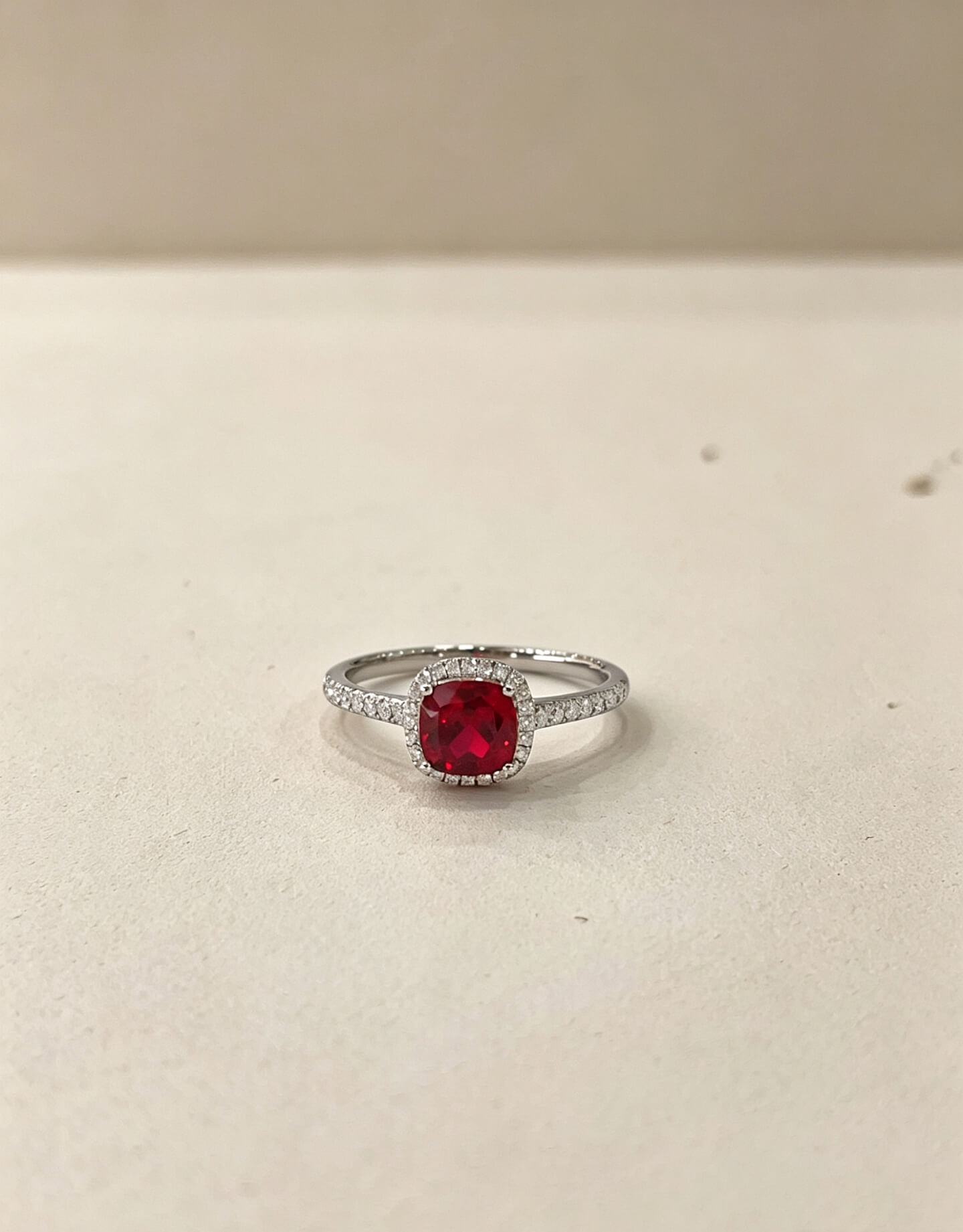 Halo setting cushion cut lab grown ruby engagement ring