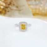 Halo setting cushion cut lab grown yellow diamond engagement ring