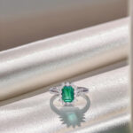 Halo setting lab grown emerald engagement ring