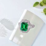 Halo setting lab grown emerald engagement ring
