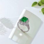 Halo setting lab grown emerald engagement ring