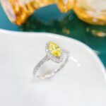 Halo setting marquise cut lab grown yellow diamond engagement ring