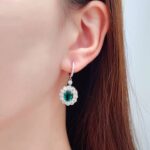 Halo setting oval cut lab grown emerald hoop earrings