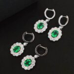Halo setting oval cut lab grown emerald hoop earrings