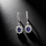 Halo setting oval cut lab grown sapphire hoop earrings