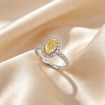 Halo setting oval cut lab grown yellow diamond engagement ring