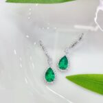 Halo setting pear cut lab grown emerald hoop earrings