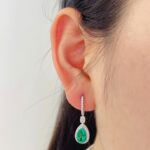Halo setting pear cut lab grown emerald hoop earrings