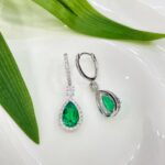 Halo setting pear cut lab grown emerald hoop earrings