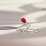 Halo setting pear cut lab grown ruby engagement ring