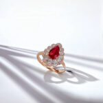 Halo setting pear cut lab grown ruby engagement ring