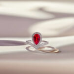 Halo setting pear cut lab grown ruby engagement ring