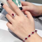 Halo setting pear cut lab grown ruby engagement ring
