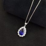 Halo setting pear cut lab grown sapphire pendant necklace 2 Halo setting pear cut lab grown sapphire pendant necklace 01