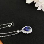 Halo setting pear cut lab grown sapphire pendant necklace 4 Halo setting pear cut lab grown sapphire pendant necklace 01