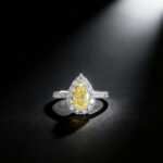 Halo setting pear cut lab grown yellow diamond engagement ring