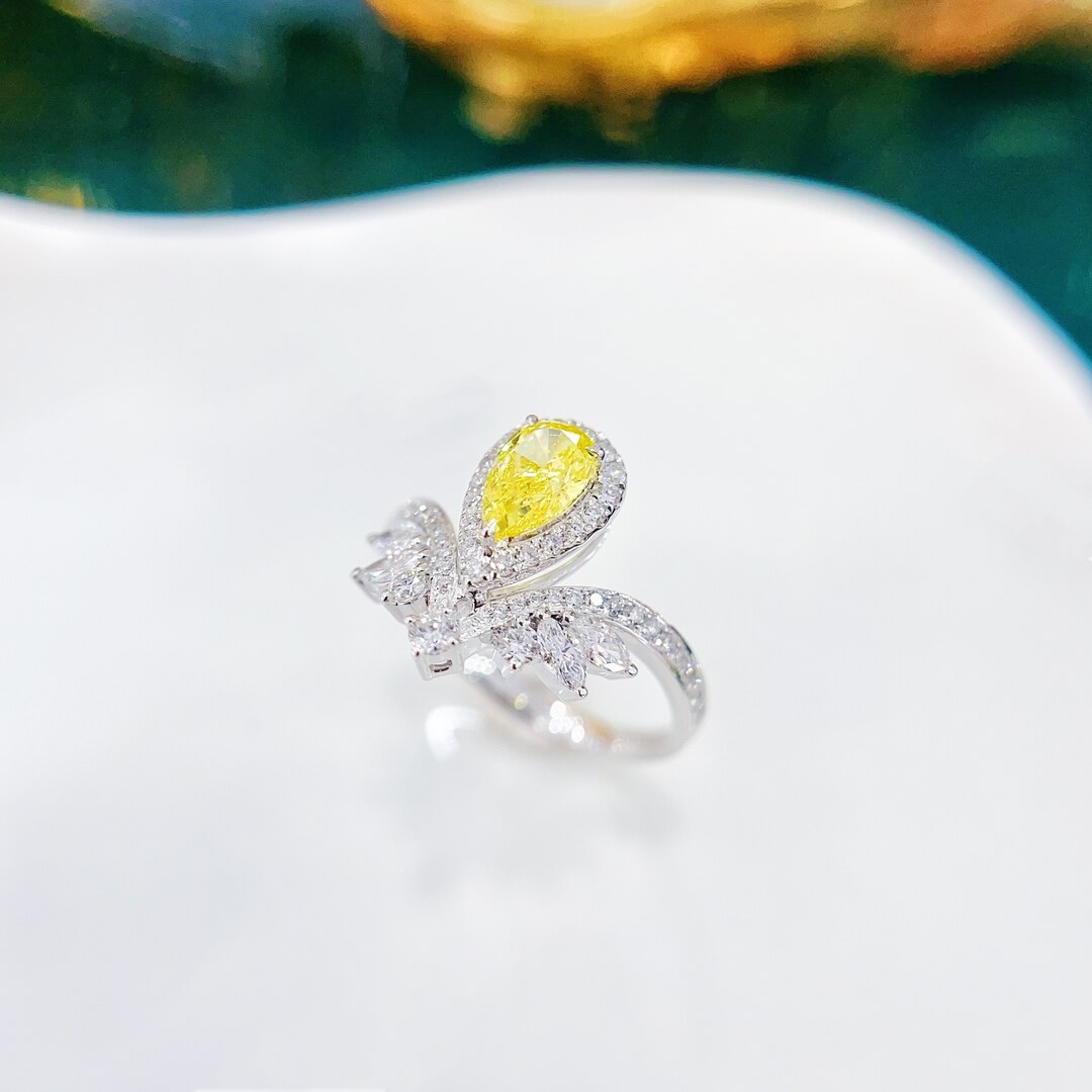 Halo setting pear cut lab grown yellow diamond engagement ring