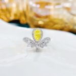 Halo setting pear cut lab grown yellow diamond engagement ring