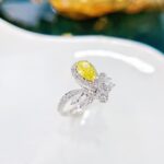 Halo setting pear cut lab grown yellow diamond engagement ring