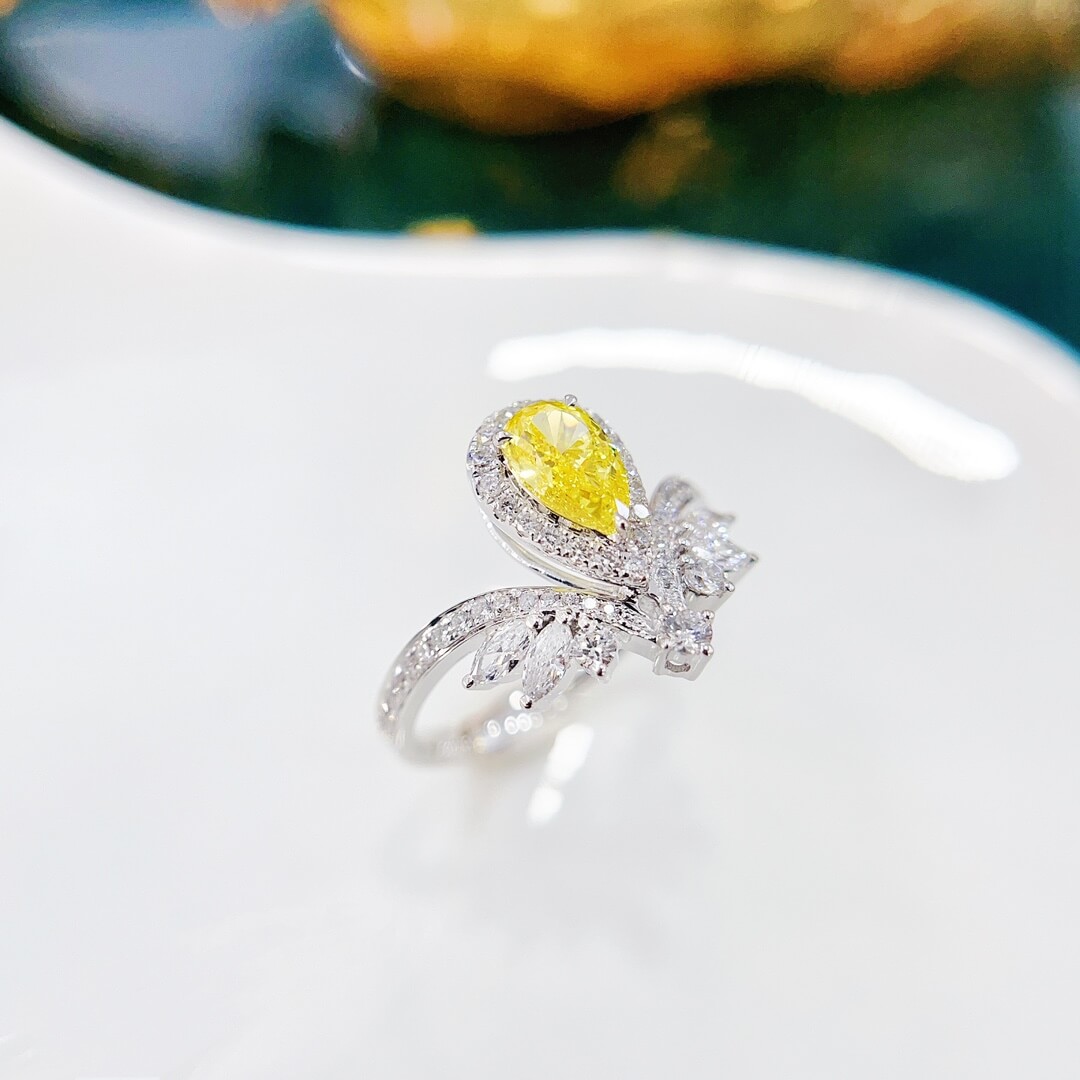 Halo setting pear cut lab grown yellow diamond engagement ring