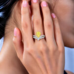 Halo setting pear cut lab grown yellow diamond engagement ring