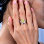 Halo setting pear cut lab grown yellow diamond engagement ring