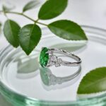 Oval cut lab grown emerald engagement ring